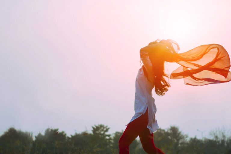 woman-moves-with-scarf-in-sky